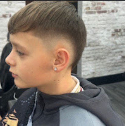 High skin fade with a crisp line-up at the temples