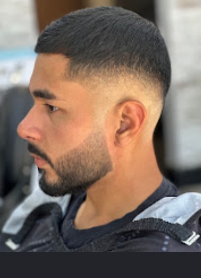 Skin fade paired with a sculpted beard and sharp razor line-up